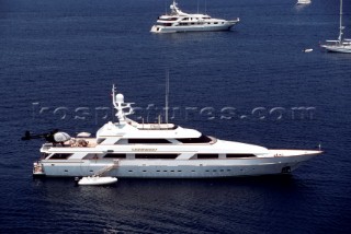 Superyachts at anchor in calm sea