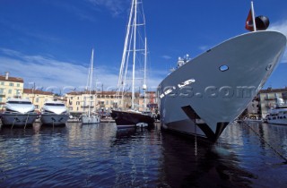 Bow of superyacht in St Tropez harbour amongst maxi yachts and motor yachts