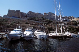 Line of moored superyachts and maxi sailing yachts in Bonifacio, Corsica