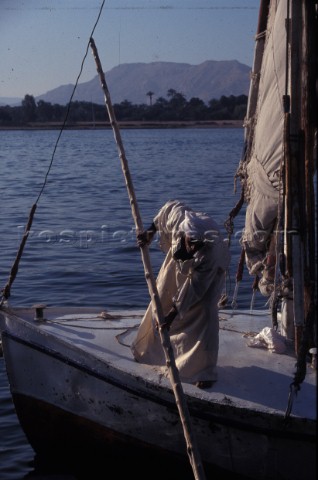 Egypt  The Nile at Luxor Man pushes off on Felucca