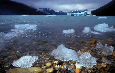 Chunks of Ice and Icebergs on a lake surrounded by mountains