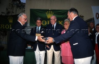 From right: His Highness the Aga Khan, Mr & Mrs Andre Heiniger, President of Rolex Geneva and Gian Riccado Marini, President of Rolex Italy, present the awards to King Constantine of Greece. Maxi Yacht Rolex Cup 1995. Porto Cervo, Sardinia.