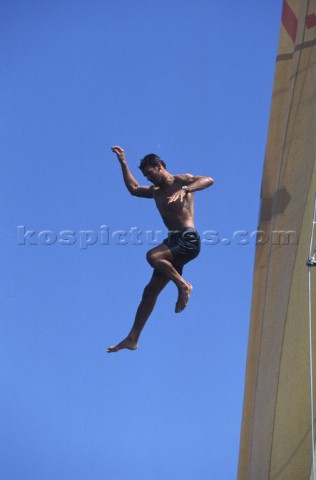 A man jumps from a mast