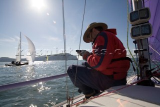 Male navigator using GPS to sail in a yacht race Round the Island Race on a J80 sportsboat