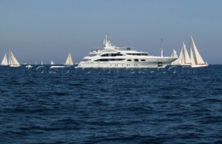 Superyacht with sailing yachts in St Tropez