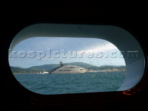 Superyacht designed by Norman Foster through porthole in the Mediterranean