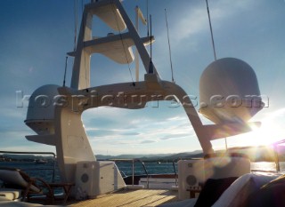 Superyacht in the Mediterranean. Navigation mast with Furnuo radar and communication aerials and satcom dishes