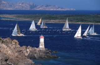 Fleet of Swan yachts racing through the Maddalena Islands off Port Cervo Sardinia during the Rolex Swan World Cup