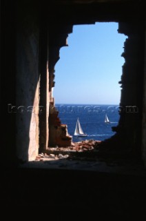 Fleet of Swan yachts racing through the Maddalena Islands off Port Cervo Sardinia during the Rolex Swan World Cup