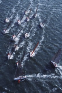 A ‘heart-in-the-mouth’ moment for the crew of American Farr 40 One Design yacht Predator as they approach the first windward mark during a Farr 40 World Championships. The big gamble they have taken is to approach the first mark in the clear wind on the left side of the race course, whilst the whole fleet approaches with right-of-way on starboard tack from the right. Predator’s precision is a winning move and she rounds two metres clear ahead of her competitors. In contrast a British yacht following her from the left is a few seconds too late and has to bear away and sail to the back of the fleet. After 30 minutes of racing, determining first and last place is a matter of one boat length..