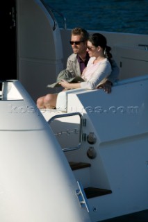 Couple sitting on aft of  a power boat.