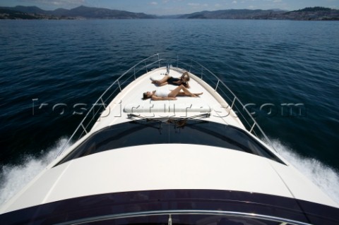 Two women sunbathing on powerboat
