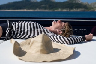 Woman sunbathing on a powerboat