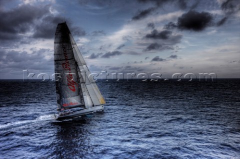 The canting keel maxi yacht Alfa Romeo offshore in a storm with clouds and stormy sky during the La 