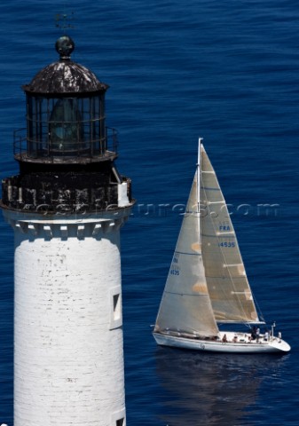 Yachts rounding the Giraglia Rock Lighthouse on the island in the Mediterranean