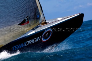 Team Origins GBR-75 makes its maiden voyage from Port Americas Cup in Valencia in company with the yacht America.