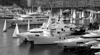 Superyachts moored in Monaco harbour port with yachts sailing
