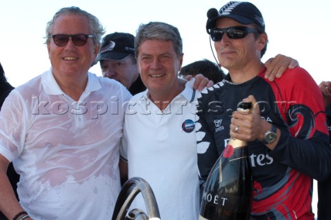 Emirates Team New Zealand helmsman Dean Barker celebrates with Bruno Trouble and Yves carcel of Loiu