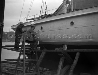A large motor yacht with its hull being painted on a slipway at Mays Yard in Lymington (now known as Berthons) in 1939
