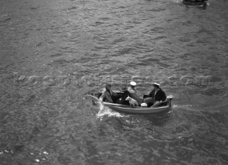 Spectators and a dog in a tender during the international mboat race in Torquay, 1938.