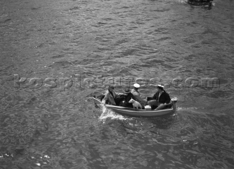 Spectators and a dog in a tender during the international mboat race in Torquay 1938