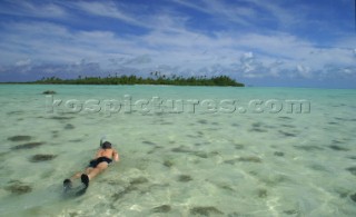 Snorkeling off Pearl beach resort on Aitutaki Island, Cook Islands, South Pacific.