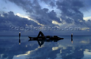 Relaxing at Pacific resort during sunset on Aitutaki Island, Cook Islands, South Pacific.