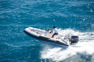 Man using a tender to the superyacht White Cloud
