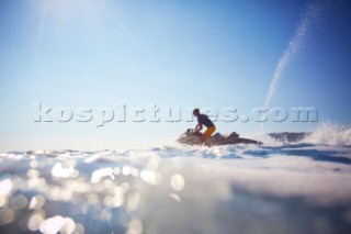 Man jet skiing in the mediterranean sea.