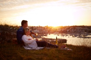 Couple relaxing on blanket in the sunset