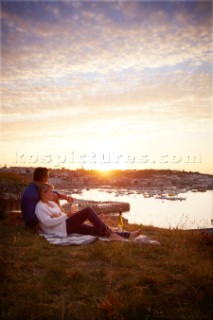 Couple relaxing on blanket in the sunset
