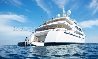Couple relaxing on beach deck of a superyacht