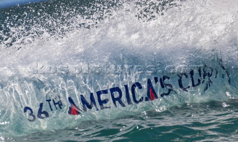 Bow wave splash of camera boat with AC logo