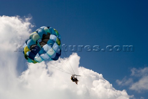 Tourists enjoy a parasail ride above the ocean Turks and Caicos