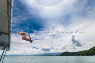 A girl jumps from the roof of a boat into the ocean off the coast of Costa Rica.