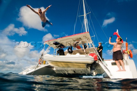 Matt Edney jumps off the swim platform of a catamaran while at anchor in the British Virgin Islands 