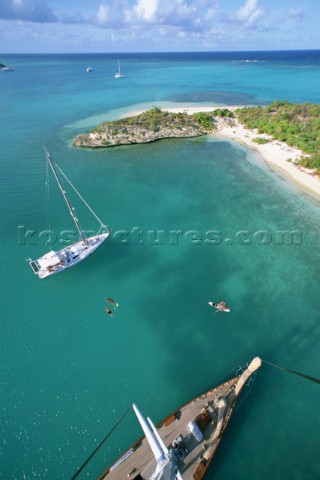 Masthead aerial view of cruising sailboats at anchor off Green Island Antigua British West Indies in