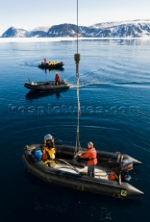 Polar guides driving motorized inflatable boats known as zodiacs, Phippsoya Island, Sjuoyane, The Seven Islands, Spitsbergen/Svalbard, Norway, on 27 June 2007. Zodiacs are used by expedition cruise ships in the polar regions to ferry passengers to shore and to take passengers on iceberg and glacier cruises.