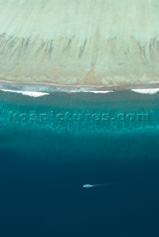 Aerial view of boat traveling along the edge of an atoll Meemu Atoll Maldives on 5 November 2007 The