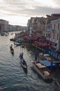 Two gondolas with tourist sails along the great canal viewed from Rialto bridge in Venice, Italy.