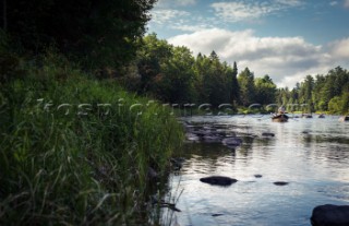 Fly fisherman fishing down the Flambeau River