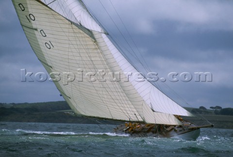 A beautiful classic yacht an 85 gaff rigged sloop races in the Americas Cup where the dark skies of 