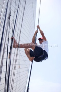 Crewman climbing aloft on board sailing yacht Altair, during the Antigua Classic Regatta, Antigua, British West Indies.