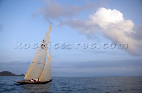 Calm winds off the Antigua coast carry the 6 Meter Nada upwind at sunset