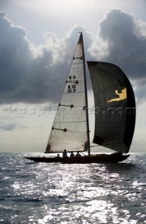 6 Meter Nada sails off the coast of Antigua at dusk.