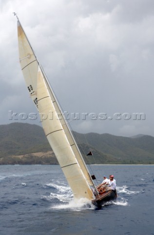 The 6 Meter Nada crshes through the waves upwind at the Antigua Classic Regatta 2006