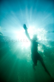 Underwater view of Patrick Orton swimming on the surface of Lake Pend Oreille near Sandpoint, Idaho.