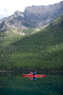 Andy Feuling and daughter River paddle their kayak on Bowman Lake in   Glacier National Park, Montana.