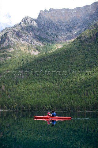 Andy Feuling and daughter River paddle their kayak on Bowman Lake in   Glacier National Park Montana