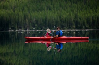 Andy Feuling and daughter River paddle their kayak on Bowman Lake in  Glacier National Park, Montana.